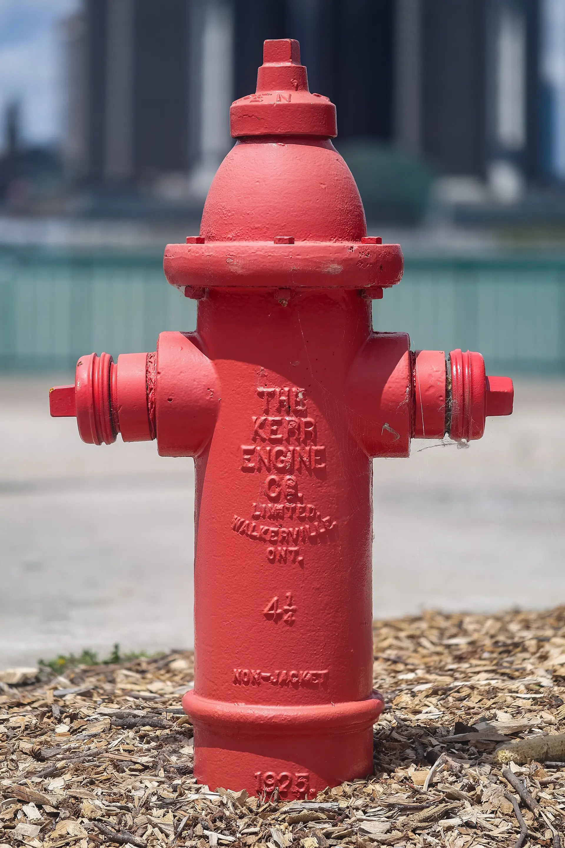 Red fire hydrant standing on a gravel bed